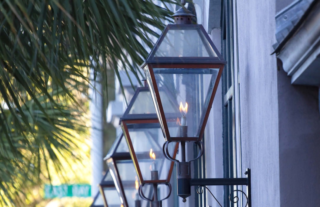 row of lamp sconces on building exterior
